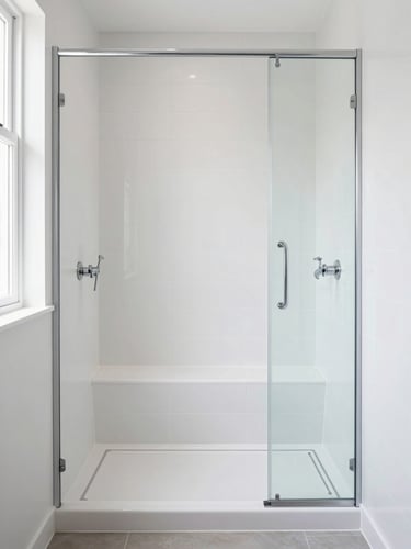 Straight-on shot of an elegant white tile walk-in shower with an integrated built-in bench, chrome hand shower, and clean glass screen. Bright natural light illuminates the space, highlighting the clean grout lines and modern fixtures.