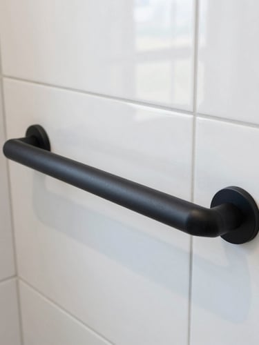 Close-up of a modern matte black safety grab bar seamlessly integrated into a beautifully tiled walk-in shower wall, bright daylight reflecting off the clean ceramic surface.