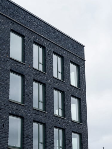 Clean architectural detail of a modern brick office building in Billericay, soft overcast British daylight, sharp focus, 35mm