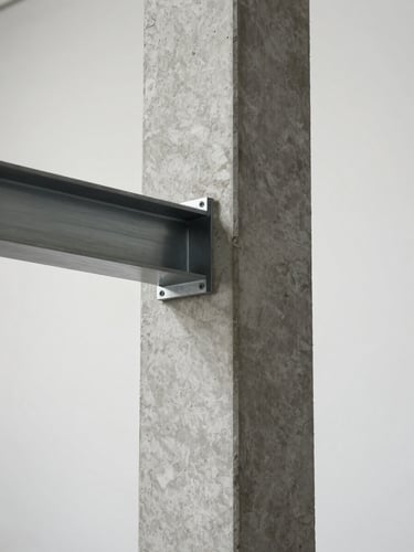 Close-up of a poured concrete column meeting a polished steel beam joint, diffused studio light revealing the material grain and precise tolerances, minimal negative space at the frame edges, no people