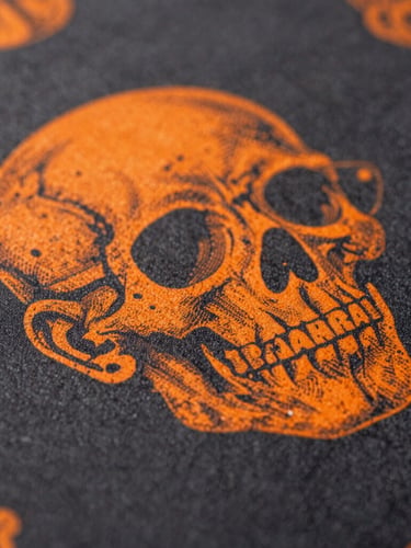 Extreme macro shot of a vibrant DTF print transfer on dark fabric, crisp details, high contrast studio lighting, orange highlights