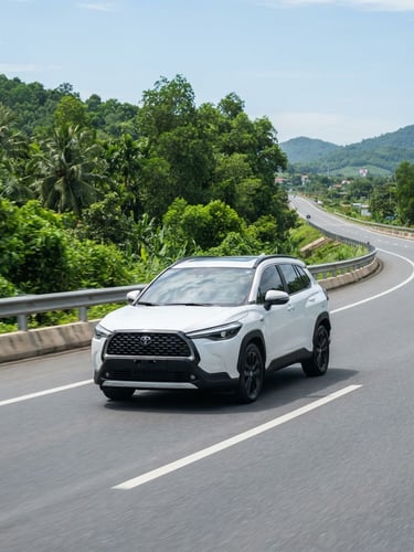 A modern white SUV driving on a clean, sunlit highway in Vietnam, bright natural daylight, green trees in the background, professional vehicle photography, 50mm lens