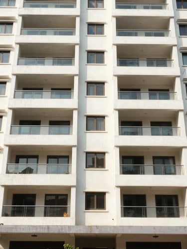 Straight-on architectural shot of a modern apartment building exterior in Bangalore, clean lines, natural daylight, realistic Indian urban setting.