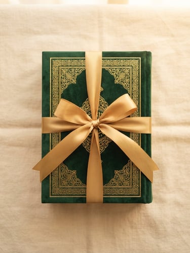 Overhead shot of a beautifully packaged Quran in a green box with gold ribbon, resting on a clean cream surface, warm morning light, 35mm