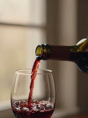 Close-up of rich red wine being poured from a traditional glass demijohn into a clear bottle, soft low-key ambient lighting highlighting the deep bordeaux tones, 35mm photography