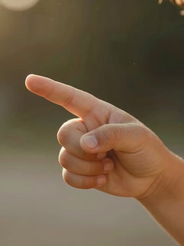 Close-up of a child's hand holding their parent's finger, warm golden hour sunlight filtering through, soft focus.