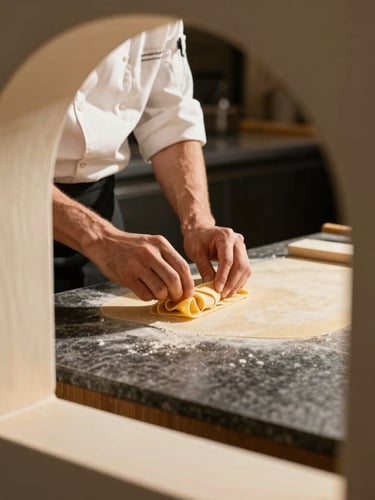 Close-up of hand-made pasta being plated on a dark stone counter, chef hands visible, warm dramatic side light, 35mm lens