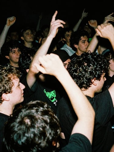 Slam pit crowd in motion, blurry limbs, harsh strobe light, deep xerox black tones, portrait aspect.