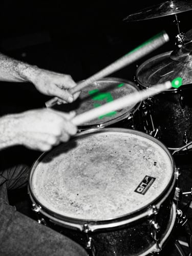 Hands drumming violently on battered snare drum, motion blur, harsh black and white, portrait aspect.