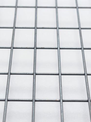Extreme close-up macro shot of welded wire mesh sheet, flat-lay overhead, bright even studio lighting, sharp focus on weld intersections showing consistent spacing and clean fused joints, cold white light, no shadows obscuring the grid openings
