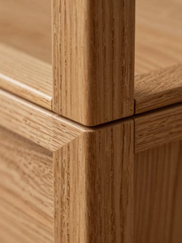 Extreme close-up macro shot of a perfectly executed wood joint, warm oak texture, seamless architectural millwork detail under soft side lighting.