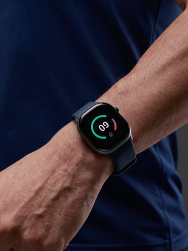 Close-up of premium wearable biometric tech on an athlete's wrist, cool crisp studio lighting, deep navy tones, high-contrast, professional execution