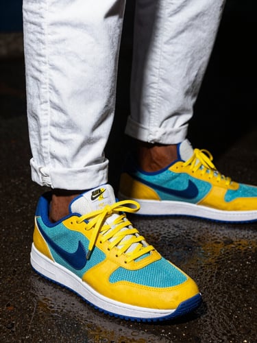 Dynamic low-angle shot of fresh sneakers on wet Nairobi pavement, high-contrast flash lighting, vibrant urban streetwear aesthetic