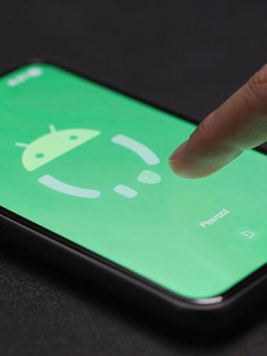 A macro close-up shot of a modern bezel-less Android phone displaying a fluid green glowing interface, fingers interacting with the screen, shallow depth of field, moody low-key studio lighting.