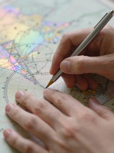 Portrait close-up of delicate hands tracing an astronomical map, soft-focus, warm light leaks, iridescent pastel overlays.