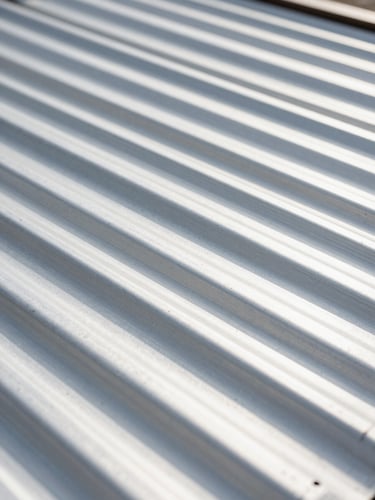 Close-up of clean steel corrugations, bright natural daylight, clean metallic textures, sharp focus, high-contrast architectural details, 35mm