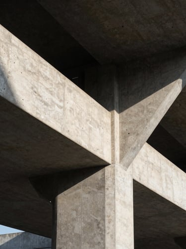Straight-on architectural detail of a modern concrete and steel structure, sharp shadows, high-contrast morning light, geometric lines.