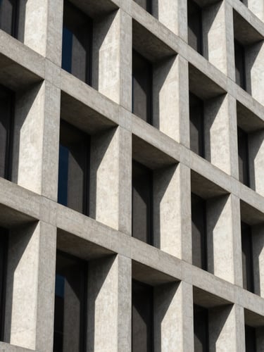 Geometric, straight-on architectural detail of a modern concrete and steel corporate facade in Cedar Rapids. Crisp, high-contrast side-lighting casts deep, razor-sharp shadows across structured surfaces, emphasizing absolute discipline.