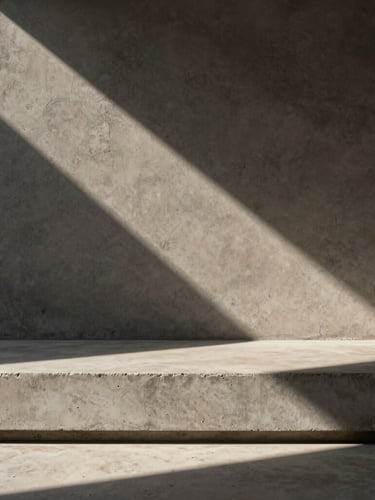 Stark minimalist concrete threshold with a sharp, dramatic architectural shadow cast across a raw textured wall, hard direct sunlight, medium format editorial photography.