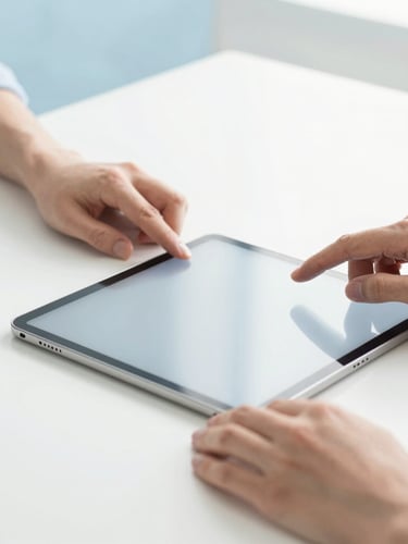 Close-up of hands adjusting creative tools next to a modern tablet on a clean white desk, soft natural daylight, high-key editorial look