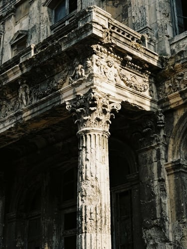 Dramatic architectural detail of a decaying classical facade, high-contrast natural light, deep shadows, desaturated tones, 35mm film look