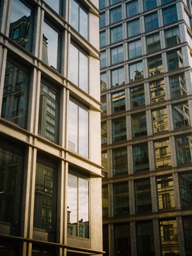 Architectural details of a modern business hub in Paris, soft natural light reflecting off clean glass and steel structures, warm golden tones, 35mm editorial photography