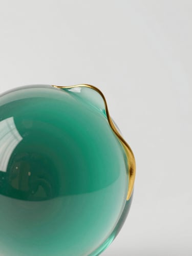 Macro close-up of a fluid 3D glass sculpture with gold caustics reflecting emerald and soft teal light, clean minimalist studio background, 8k resolution
