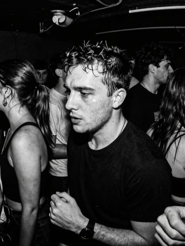 Gritty black and white flash photography of a crowded underground club basement, high contrast, heavy xerox grain, fisheye lens, sweat and raw energy.