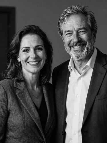 Editorial portrait of founders Fernanda and Wagner, professional journalists, smiling, warm natural lighting, high contrast black and white, sophisticated atmosphere.