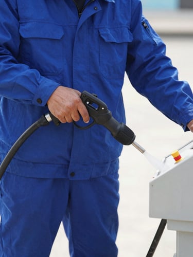 Close-up of a professional sanitation technician in a clean uniform operating a high-pressure water jetting system, bright daylight, sharp focus on the control panel.