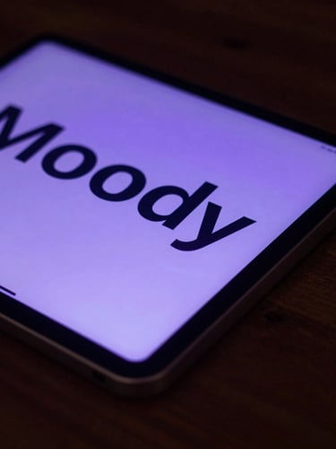 Moody close-up of a tablet on a dark oak desk displaying crisp typography, soft purple backlighting, low-key dusk ambient light, 35mm