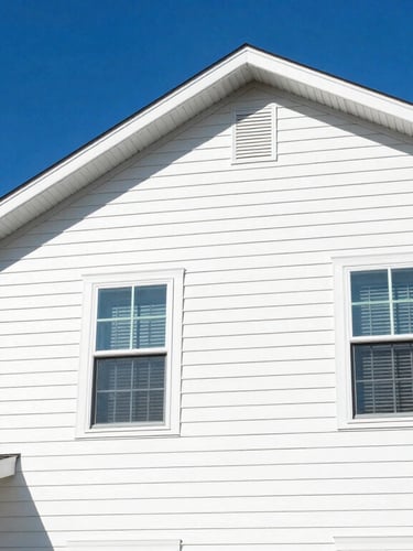 Low-angle hero shot of a beautiful clean suburban house under bright midday sunlight, vibrant blue sky, sparkling clean white vinyl siding, crisp focus, saturated color.