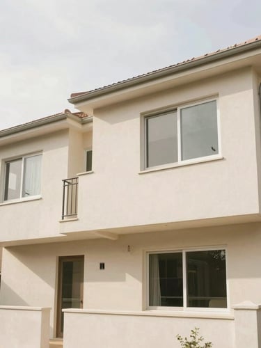 A bright, warm residential duplex exterior under natural overcast daylight, clean architectural lines, 35mm lens
