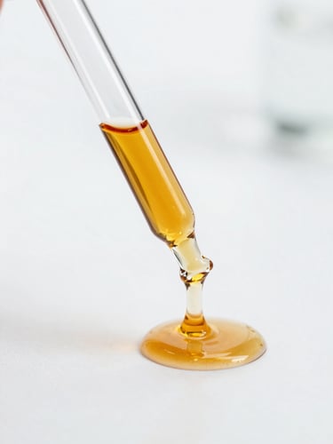 Close-up of a glass laboratory pipette dispensing a clear amber serum onto a pristine white surface, clinical studio lighting, precise and scientific composition.