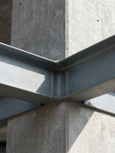 Extreme close-up of a flawless concrete-to-steel junction, sharp natural light casting geometric shadows, technical precision, architectural detail