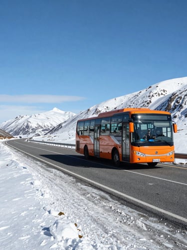 A modern long-distance bus driving safely on a winding Patagonian mountain highway, snow-covered roadside, clear daytime visibility under crisp alpine sky.