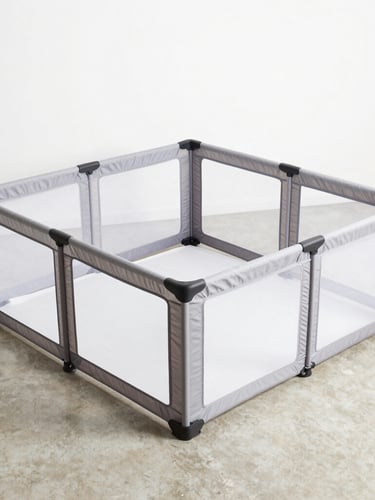 Overhead flat-laid unassembled modular playpen components on a clean concrete floor, bright studio lighting, soft shadows