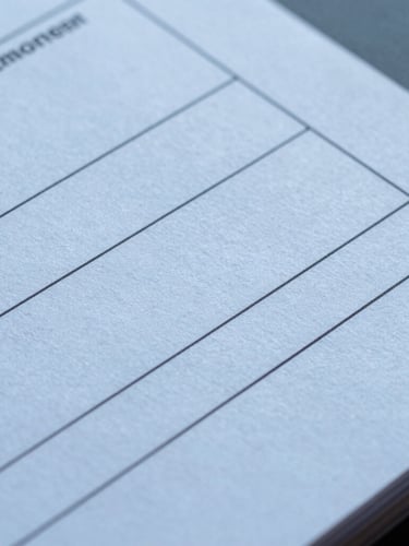 Macro shot of high-end technical documentation printed on heavy textured paper, clean typography, cool blue studio lighting, sharp focus on structured margins