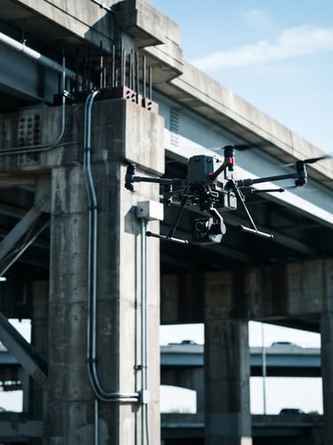 Industrial drone with LiDAR payload hovering near a bridge structure, crisp daylight, high contrast, cool technical tones, 35mm.