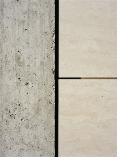 Straight-on architectural detail shot of a perfect shadow-gap joint between raw concrete and smooth travertine, crisp natural daylight, sharp shadows, 35mm lens