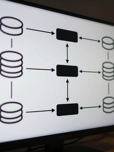 A precise black and white architectural system diagram on a screen, showing clean lines, database nodes, and API gateways, cool-toned ambient light