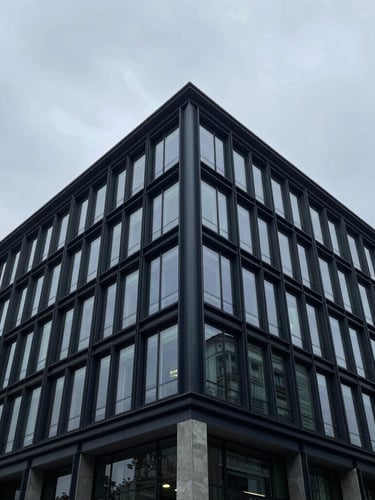 Wide-angle architectural detail of a modern corporate office facade with clean geometric lines, cool overcast daylight, sharp focus, 35mm