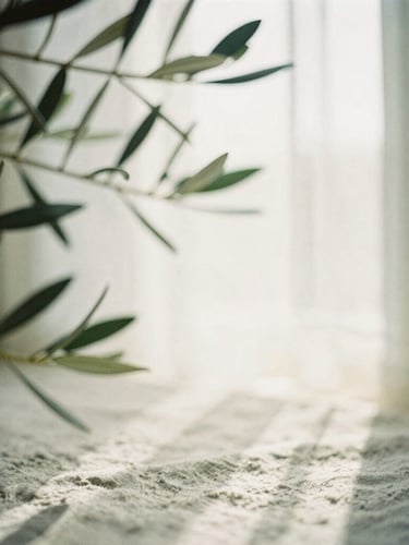 Soft morning sunlight filtering through olive leaves, casting gentle shadows on a linen surface, warm tones, 35mm