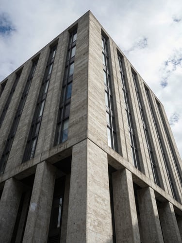 Low-angle architectural view of a brutalist concrete and steel financial headquarters in London under high-contrast overcast daylight, sharp geometric shadows, clean vertical lines.