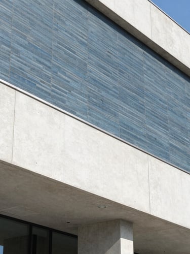 Cool architectural detail of an international institution with clean concrete lines, bright natural daylight, slate blue and crisp white tones, sharp focus, 35mm lens