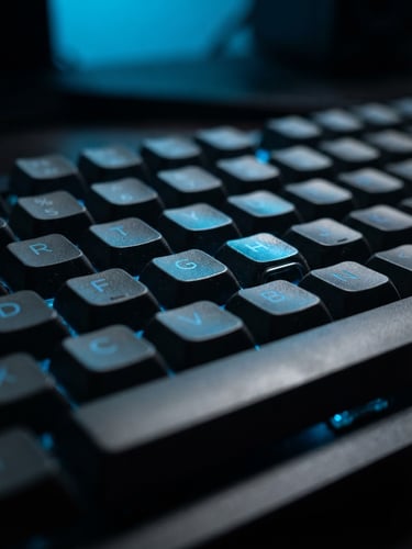 Macro shot of a mechanical keyboard with sharp neon blue screen reflections, dark ambient office lighting, shallow depth of field