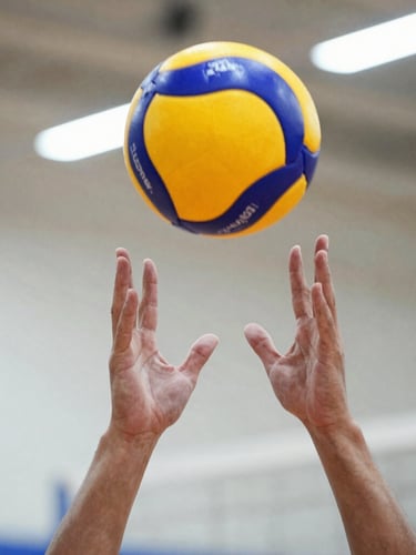 A close-up action shot of a player's hands forming a perfect passing platform, contacting a volleyball, bright indoor gym lighting, dynamic low angle, crisp athletic focus.
