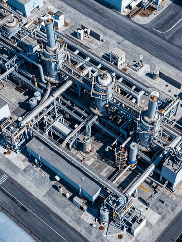 High-resolution drone orthomosaic map of an industrial plant, sharp technical aerial perspective, daylight, high-contrast blue and slate tones, 35mm