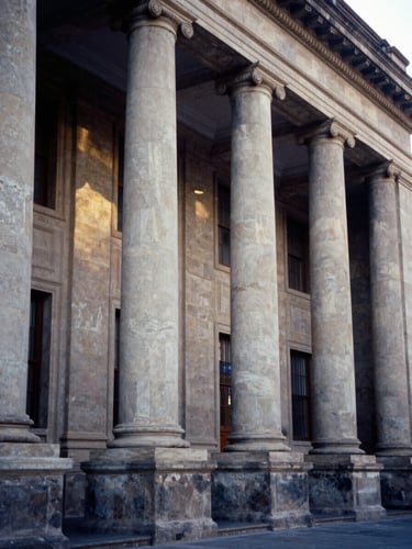 Architectural close-up of a prestigious Mexican university facade, stone columns, soft morning daylight, editorial photography, 35mm