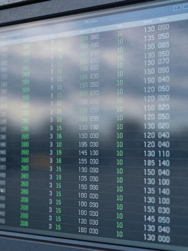 Close-up of a high-density digital data dashboard on a screen, clean blue and grey terminal interface, cool overcast daylight reflection, 35mm lens